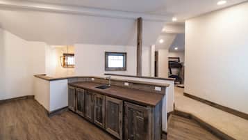 A kitchen with wooden cabinets, a sink, and a window.