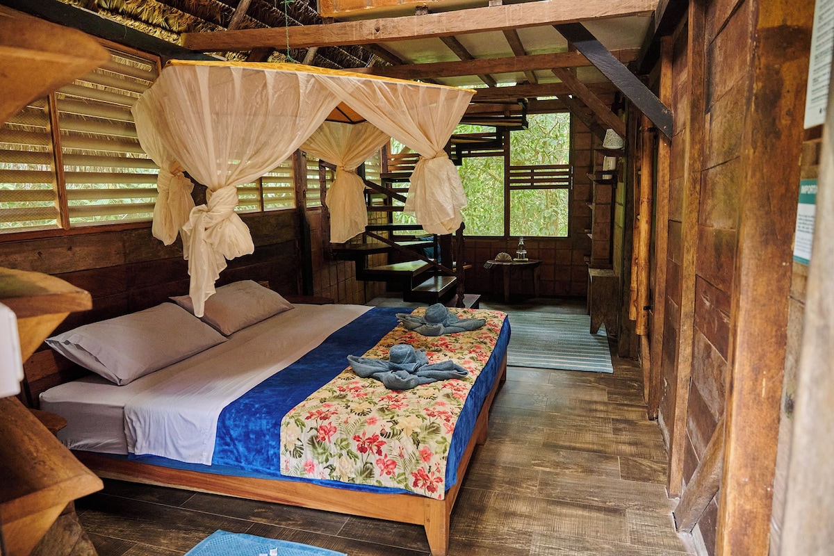 A room with a bed, a table, and a chair.