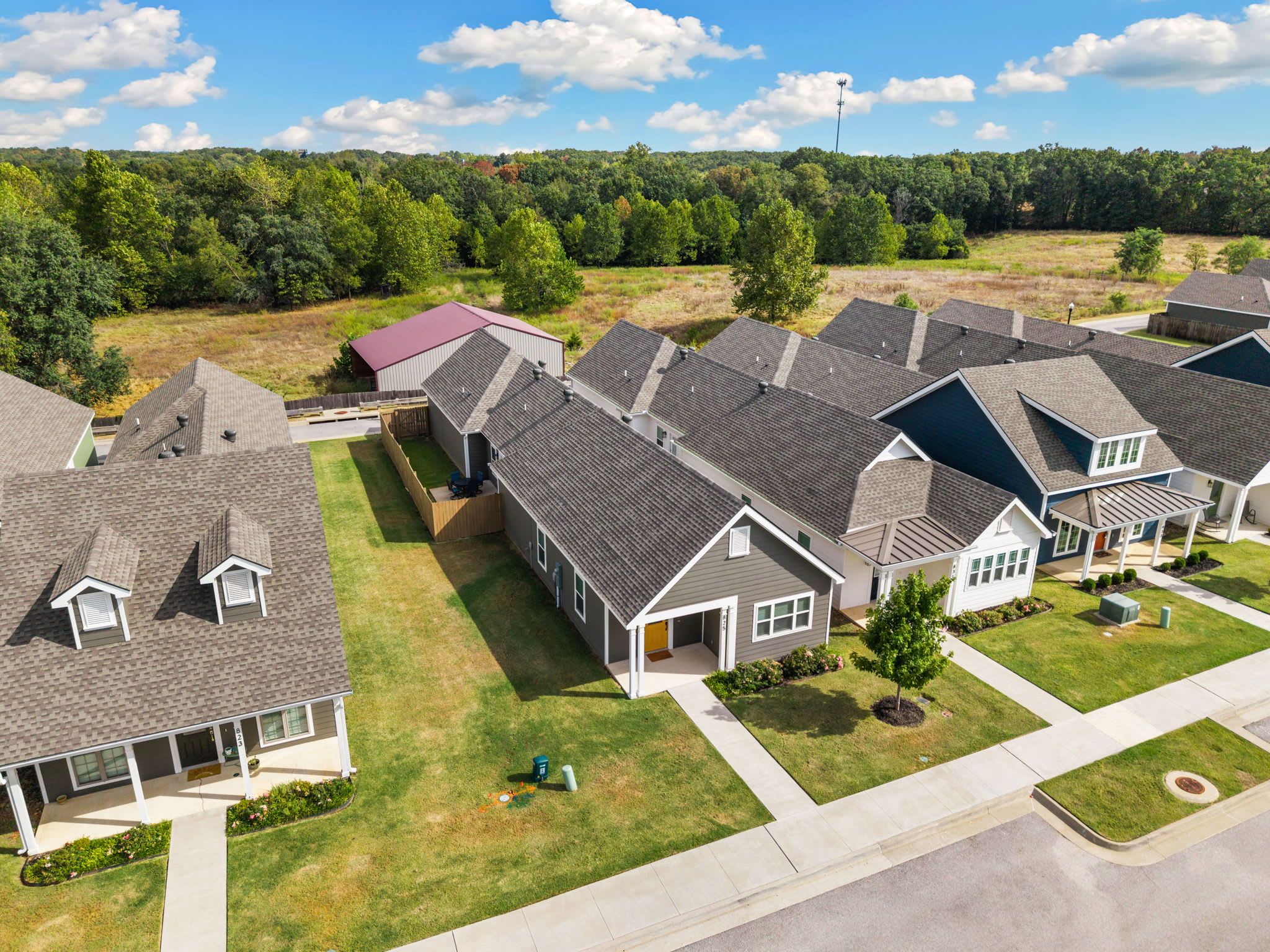 A residential area with multiple houses, each with a sloped roof and a front porch.