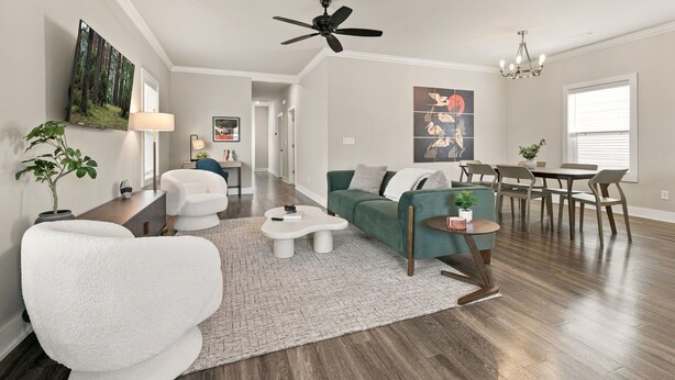 A spacious living room with a sofa, coffee table, and a dining area with chairs and a table. - Bear's Den - 2.3 mi to DT-Direct MTB Trail Access (Bentonville)