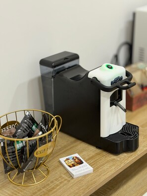 A coffee machine with a drip tray, a coffee bag holder, and a menu card on a wooden surface. - B&B Int'O'Vico – Deluxe Double Room 6 with Wi-Fi and Air Conditioning (Napoli)