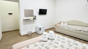 A modern hotel room with a large bed, a flat-screen TV, a small kitchenette, and a bathroom. - B&B Int'O'Vico – Premium Double Room 29 with Balcony, Wi-Fi & Air Conditioning (Napoli)