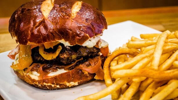 A burger with fries on a white plate. - Spacious 2BR Near Cedars-Sinai, Beverly Hills & The Grove (Beverly Hills)