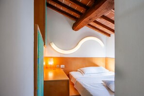 A bedroom with a wooden ceiling, a curved light fixture, a bedside table, and a bed with pillows. - Tuscan Villa | Private Garden & Florence 30 min (QUARRATA)