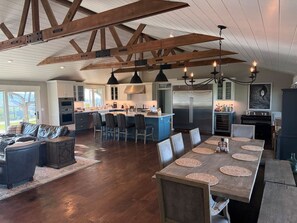A spacious kitchen with a central island, modern appliances, and a dining area with a long table. - Santa Ynez Valley Wine Country Ranch & 360 views! (Santa Ynez)