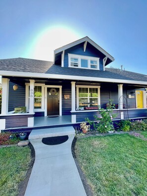 A two-story house with a front porch, a mailbox, and a number '838' on the wall.