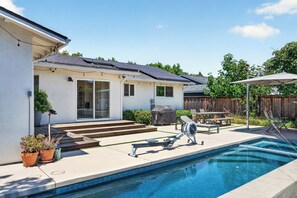 A residential backyard with a swimming pool, outdoor furniture, and a covered grill area. - Wine Country Escape in the heart of Yountville (Yountville)