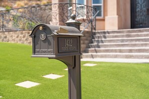 A mailbox with a house number and nameplate.