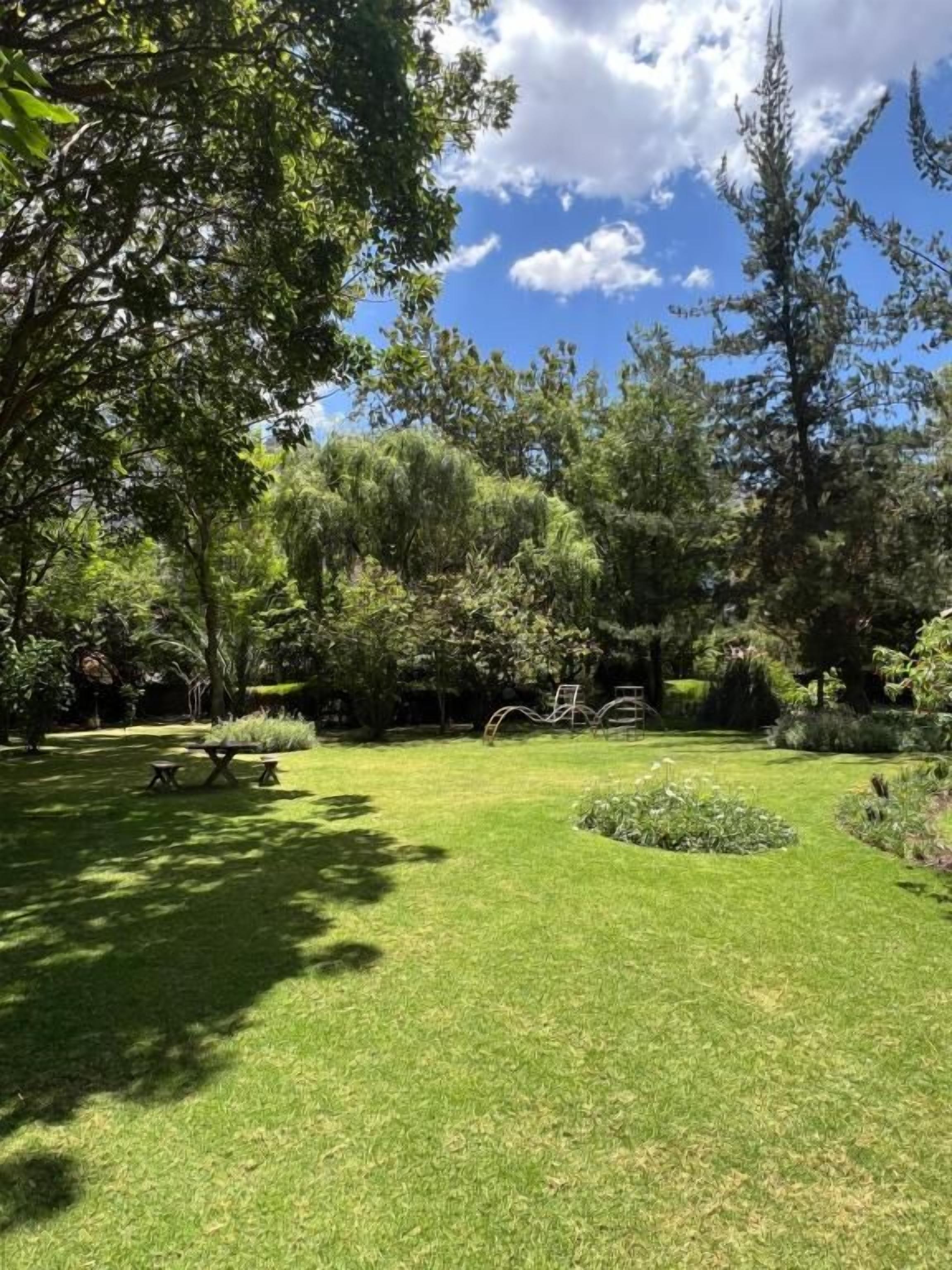 A well-maintained garden with a picnic table and a bicycle.