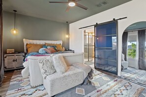 A bedroom with a bed, a sofa, a wardrobe, a ceiling fan, and a sliding glass door leading to an outdoor area. - 3 BDRM East Austin Home - Mins to Downtown (Austin)