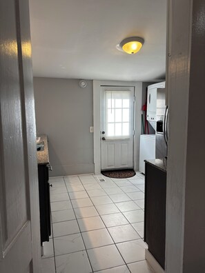 A hallway with a white door, a small window, and a ceiling light. - 1 mile to Bryant Denny Stadium (Tuscaloosa)