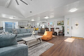 A modern living room with a sofa, coffee table, and a dining area with chairs and a table. - Bellaire Spacious 4 Br Home - sleep comfortably for 12 people + (Houston)