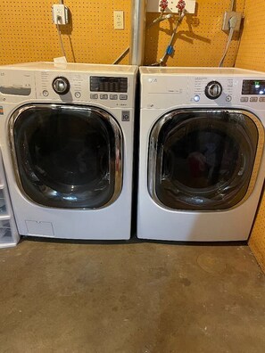 Two front-loading washing machines in a commercial setting. - Cutest House in the Best Neighborhood in town! (Sioux Falls)