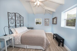 A bedroom with a bed, a desk, a chair, a ceiling fan, and a window. - Harbour Rock Villa – Oceanview Hilltop Villa (PROVIDENCIALES)