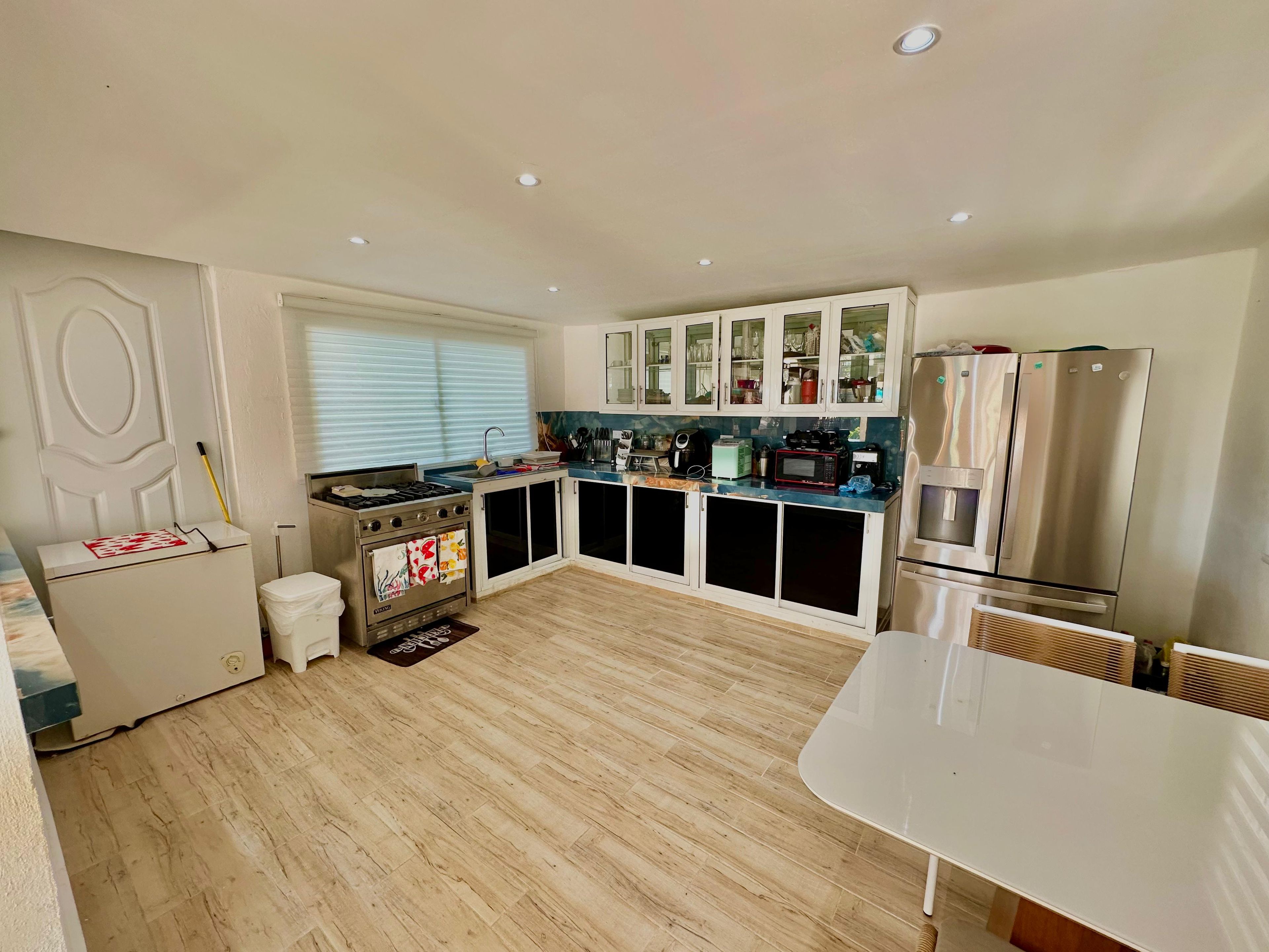 A modern kitchen with a gas stove, microwave, and stainless steel appliances.