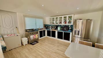 A modern kitchen with a gas stove, microwave, and stainless steel appliances.