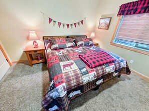 A bedroom with a bed, two bedside tables, a window with blinds, and a wall-mounted picture. - Cozy Donnelly Retreat Near Boulder Creek | Wood Stove & Garage (Donnelly)