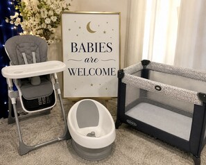 A baby changing station with a high chair, a baby bathtub, and a playpen. - 10 Min to Strip & Fremont, Pool, Games & BBQ (Las Vegas)