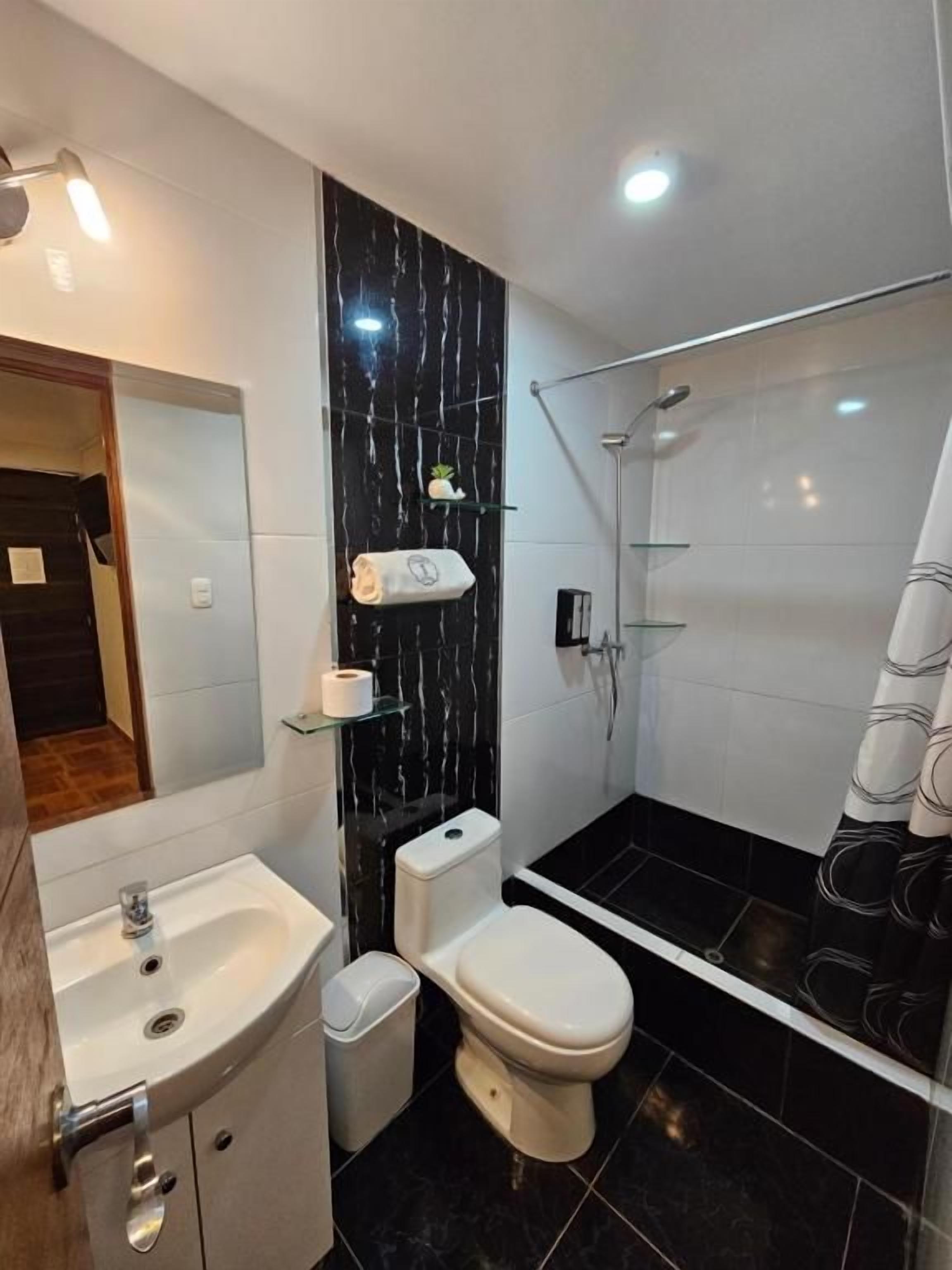 Habitación triple familiar, vista a la ciudad | Baño | Regadera, toallas, jabón, shampoo 
