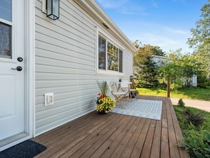 A house with a wooden deck, a door with a doorknob, and a window. - Modern Two-Level Suite in Truro (Truro)