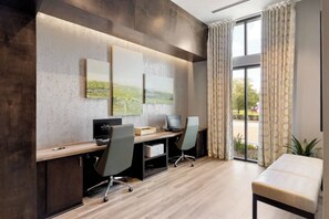A modern office space with a desk, two chairs, a computer, and a large window with curtains. - Stunning Pool View 2 Bedroom Apartment (Spring)