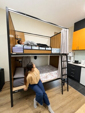 A bunk bed with a lower bunk and a desk area with a chair. - Private Ensuite Studio for 2,  (Carlton)
