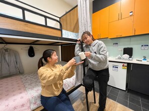 A bunk bed with a wooden frame and a lower bunk with a floral bedspread. - Private Ensuite Studio for 2,  (Carlton)