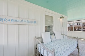 A bedroom with a bed, a window, and a sign on the wall. - Bayou Belle - Bear Point 2 BR Cottage - Orange Beach - 14 Day Min Stay (Orange Beach)