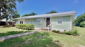 A single-story house with a front porch, a mailbox, and a number '2458' on the door. - 3BR Coastal Cottage - Steps to St. Joseph Bay (Port St. Joe)