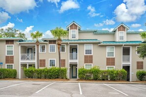 A multi-story residential building with a parking lot in front. - Village at Blue Mtn Beach 625 - Close to beach located in 30A (Santa Rosa Beach)