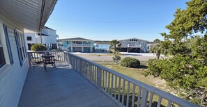 A wooden deck with a railing, overlooking a marina with boats and a body of water. - Game Time Up (Upstairs Only) - Walk to the Beach (Garden City Beach)