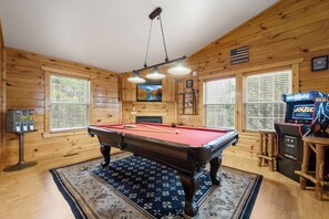 A pool table in a wooden room with a dartboard and arcade machines. - Zen Bear’s Den our Beautiful cozy cabin 2 miles to Dollywood in Pigeon Forge TN. (Pigeon Forge)
