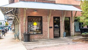 A brick building with a storefront labeled "Oxford Creamery." - "Rebel Depot" - By OVR (Oxford)