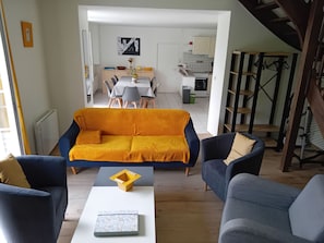 A modern living room with a sofa, chairs, and a coffee table.