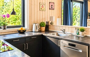 A modern kitchen with a built-in dishwasher, a kettle, and a sink. - 3 bedroom gorgeous home in Ejstrupholm (Ejstrupholm)