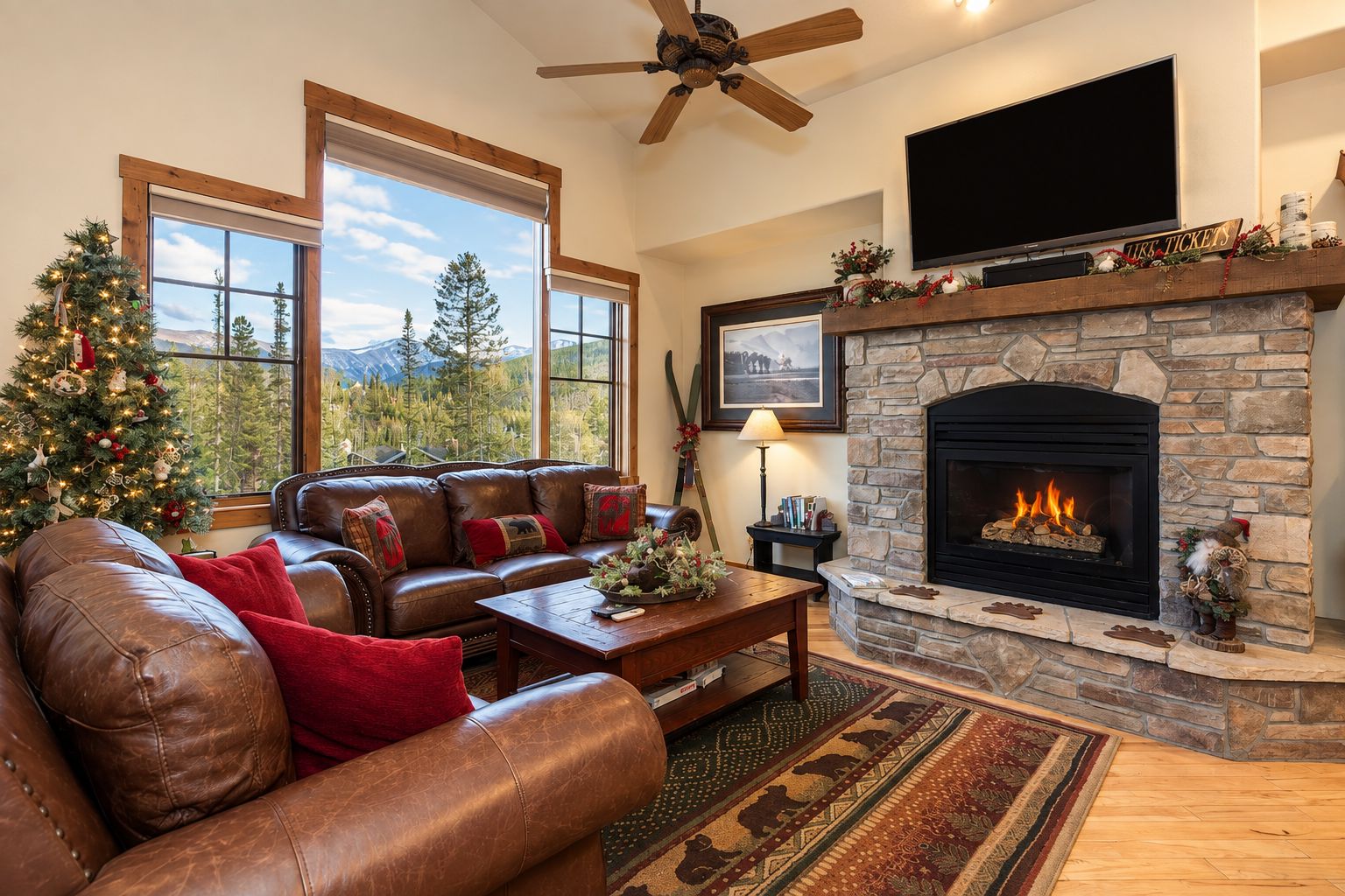 A cozy living room with a leather sofa, a fireplace, and a television.