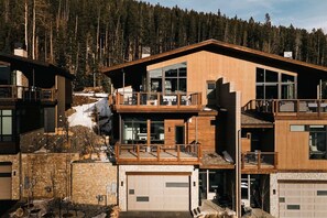 A modern multi-story building with a wooden facade, large windows, and a balcony. - Lakota Lookout | Private Hot Tub | Slope Views (Winter Park)