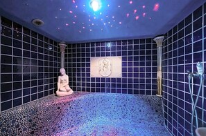 A room with a mosaic floor, a statue, and a wall-mounted emblem. - Paradies (Marlengo)