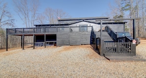 A modern two-story building with a covered deck and a carport. - Peaceful Countryside Boutique Hotel  (Commerce)