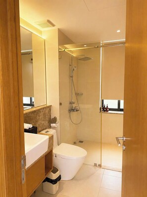 A modern bathroom with a shower, toilet, and vanity. - Coralia Cam Ranh Villa (Cam Lâm)