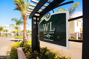 A sign for West Lucaya Village Resort with a pergola structure. - 8947 SD - 4BR Home in West Lucaya | Near Disney (Kissimmee)