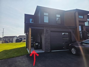 A modern two-story house with a garage, a visible mailbox, and a driveway. - Comfort Home (St. John's)