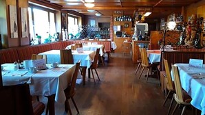 A restaurant with booths and tables, wooden flooring, and a bar area. - Alemannenhof Engel (Rickenbach)