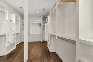 A hotel corridor with wooden flooring, white walls, and a central walkway. - Luxury Retreat Near Memorial & Heights. Sleeps 8 with Wellness Studio (Houston)