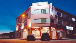 A two-story hotel with a sign reading 'HOTEL VOCE' and 'Alamflora' on the ground floor. - Vogue Rompin (Kuala Rompin)