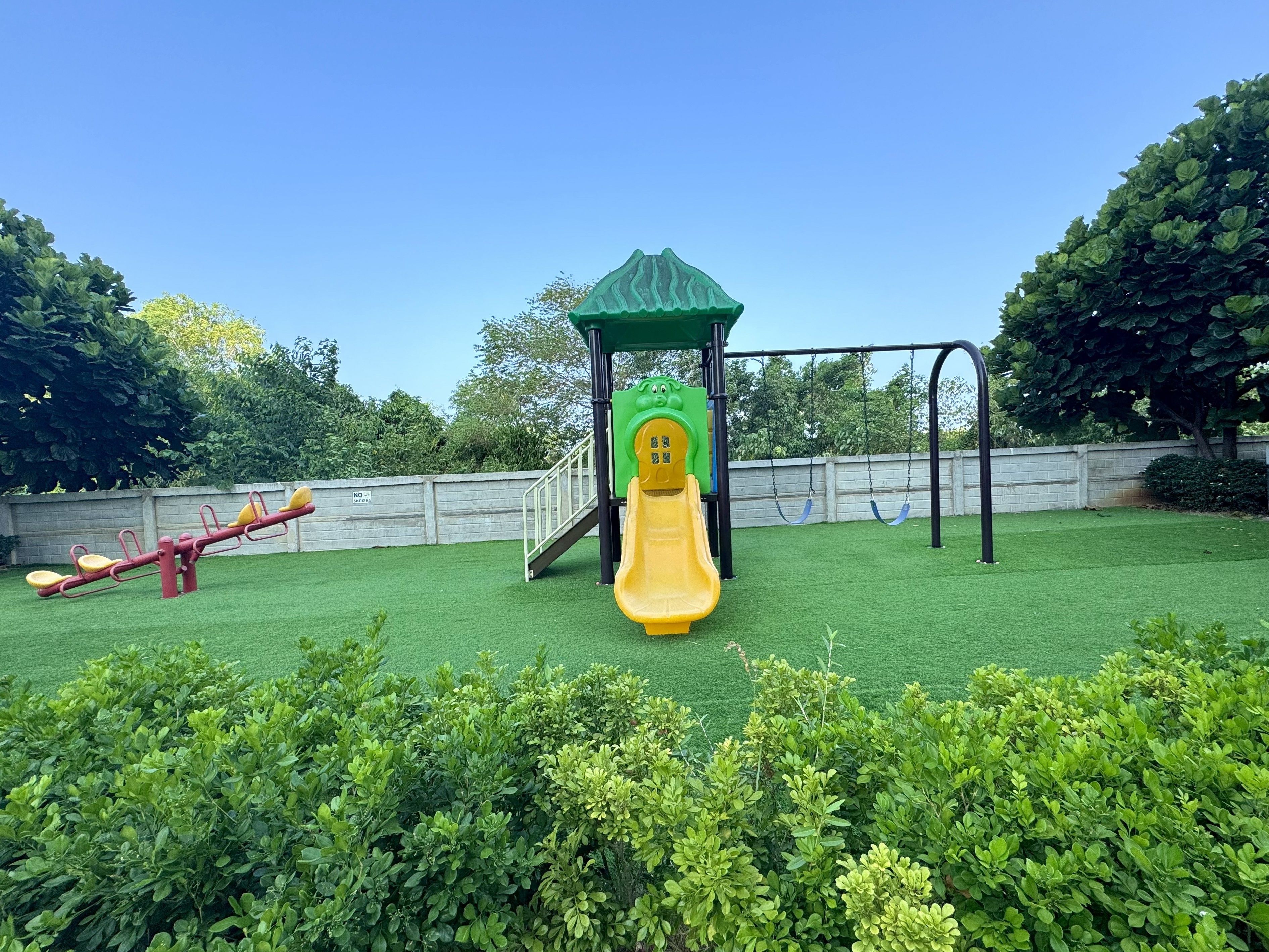 A playground with a slide and swings.