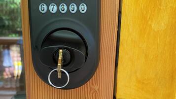 A keypad lock on a wooden door.