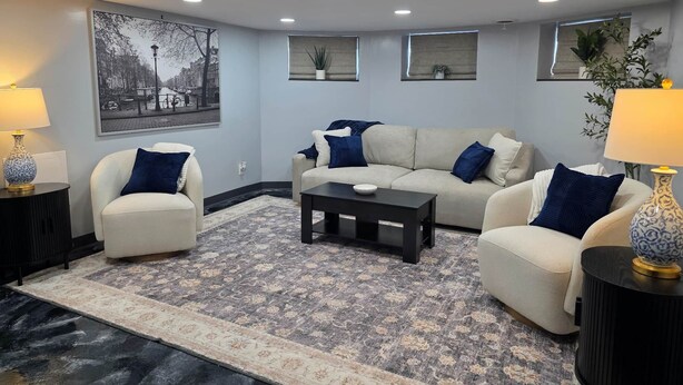 A living room with a sofa set, coffee table, and two side tables with lamps. - The Hideaway | Cozy 2BR Retreat in Pontiac (Pontiac)