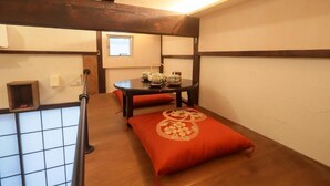 A traditional Japanese room with tatami flooring, a low table with a tea set, and a sliding door. - Tokyo Candle house (Shinjuku-ku,)