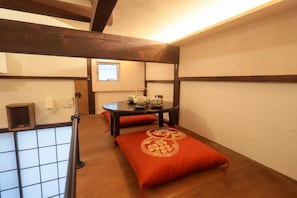 A traditional Japanese room with tatami flooring, a low table with a tea set, and a sliding door. - Tokyo Candle house (Shinjuku-ku,)
